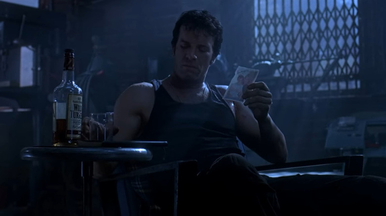 Punisher holding liquor and a picture in "The Punisher" (2004)