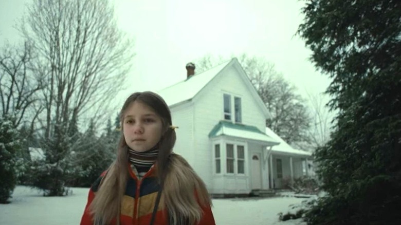 Little girl and white house