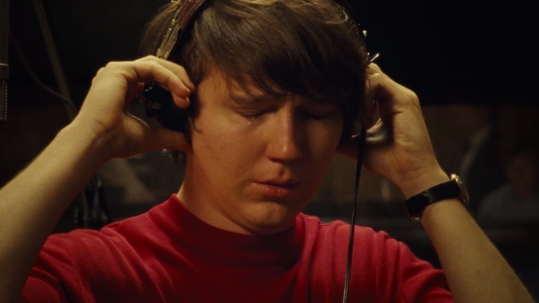  Paul Dano as young Brian Wilson wearing headphones