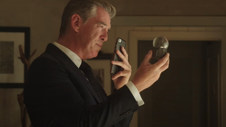 Pierce Brosnan with a snowglobe