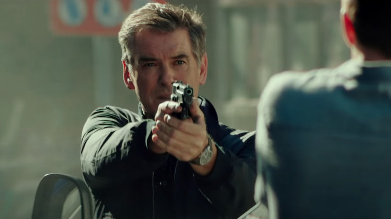 Pierce Brosnan aiming a gun