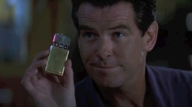 Pierce Brosnan holding a lighter