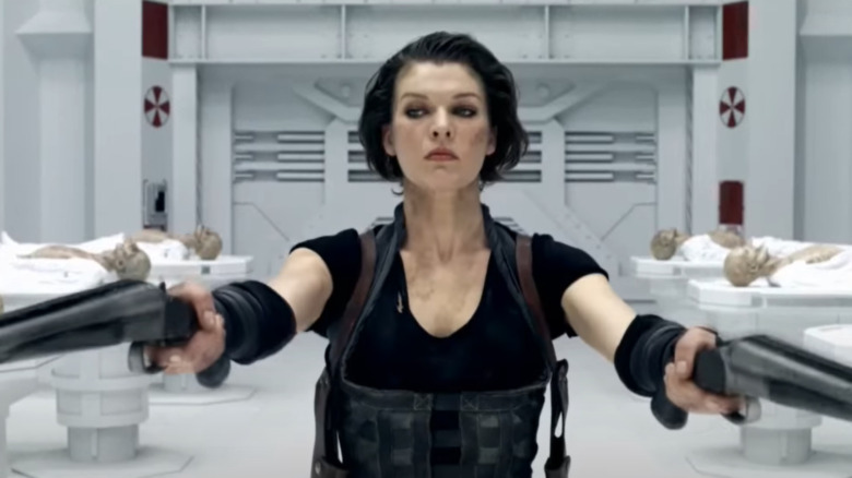 Jovovich as Alice wielding guns