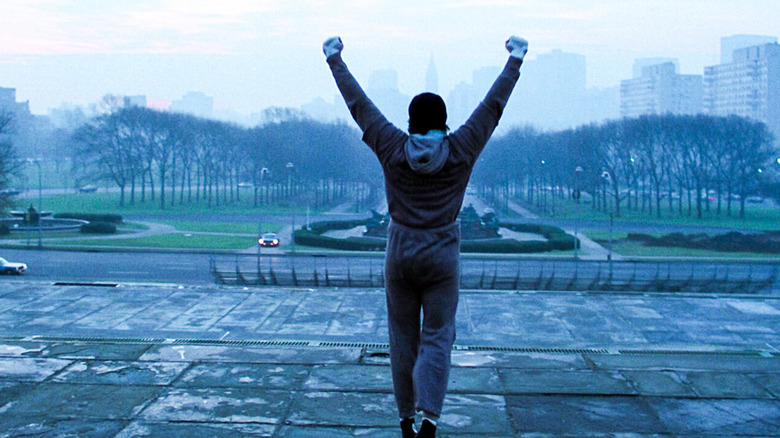 Rocky cheers at the top of the steps