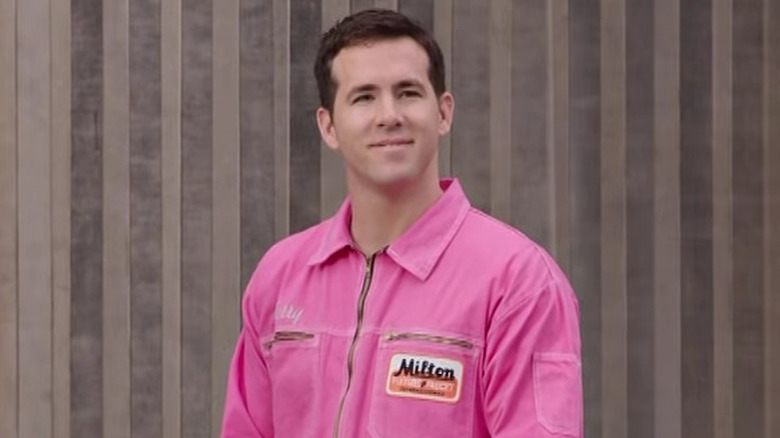 Ryan Reynolds smiles in a pink uniform