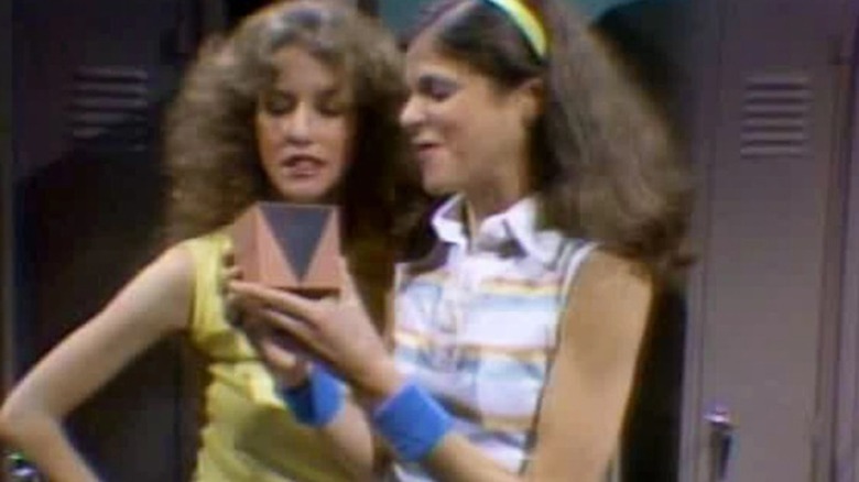 Laraine Newman and Gilda Radner look at box