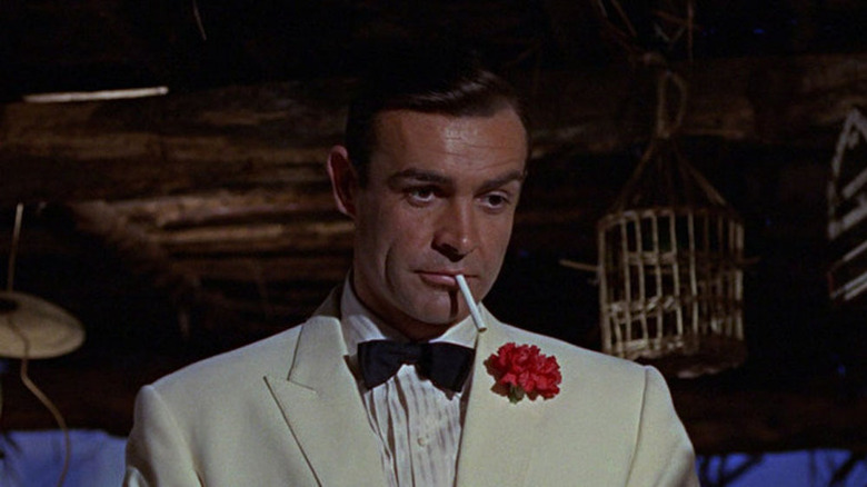 Bond holds a cigarette in his mouth