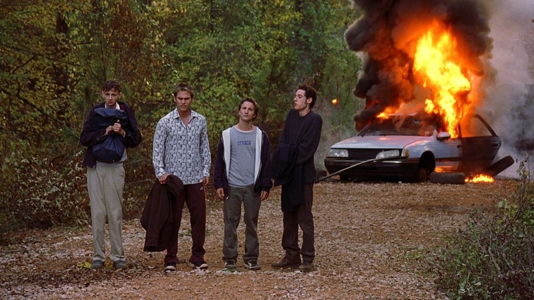 E.L. and friends in front of burning car