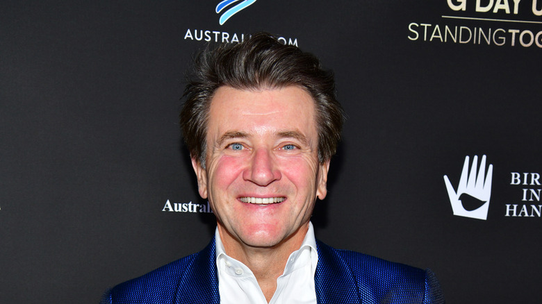 Robert Herjavec in a blue tuxedo smiling