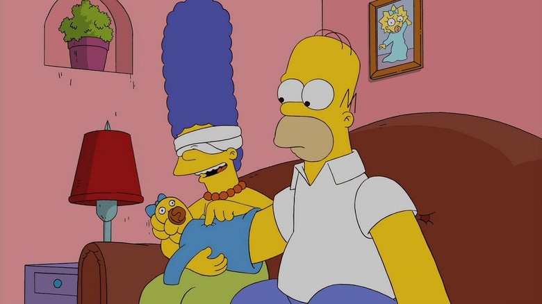 Homer Simpson's arm poses as Maggie