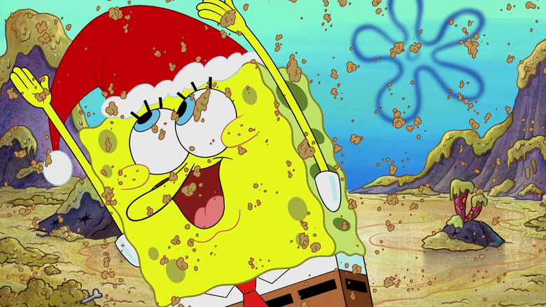 SpongeBob, wearing a Santa hat, dances under falling chum