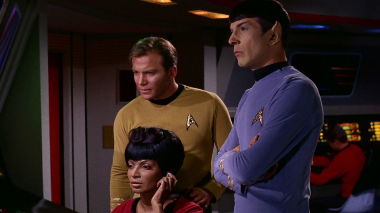 Kirk, Spock, Uhura examine alien signal