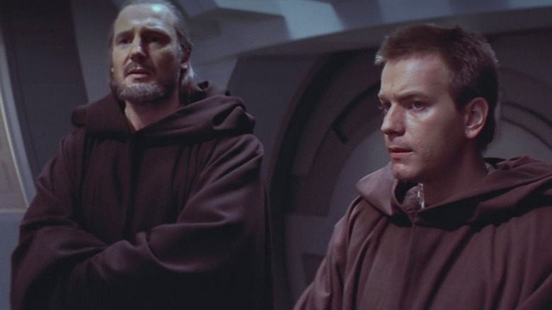 Qui-Gon Jinn stands with Obi-Wan Kenobi