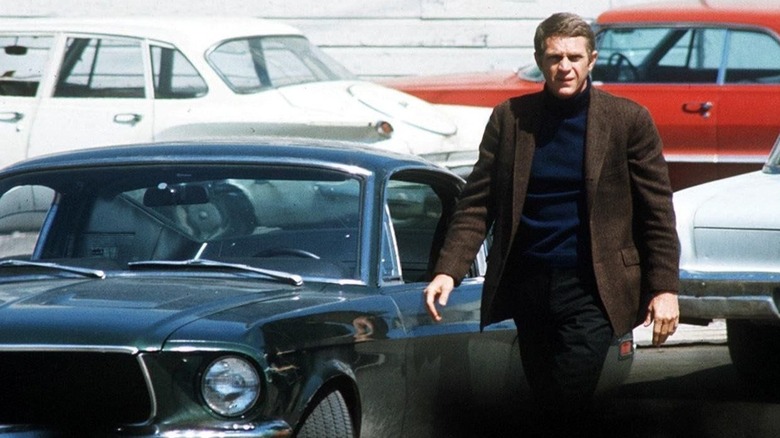 Bullitt walks beside his car