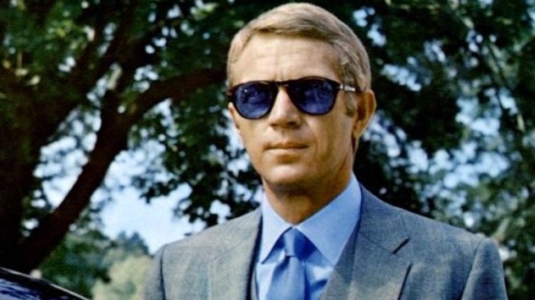 Thomas Crown in a suit and sunglasses