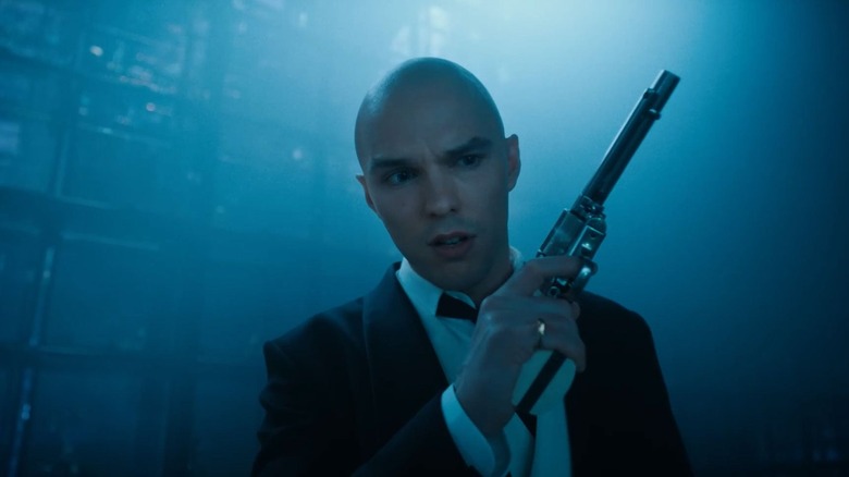 Lex Luthor admiring a gun in his hand in Superman (2025)