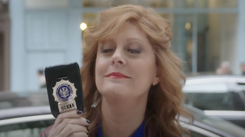 Susan Sarandon holds up police badge