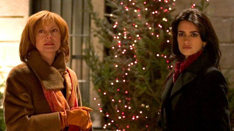 Susan Sarandon and Penelope Cruz stand by a Christmas tree