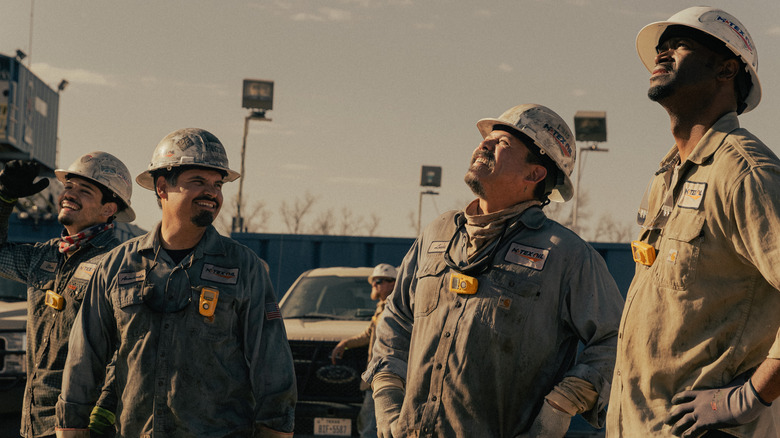 A group of oil field workers celebrate in "Landman"