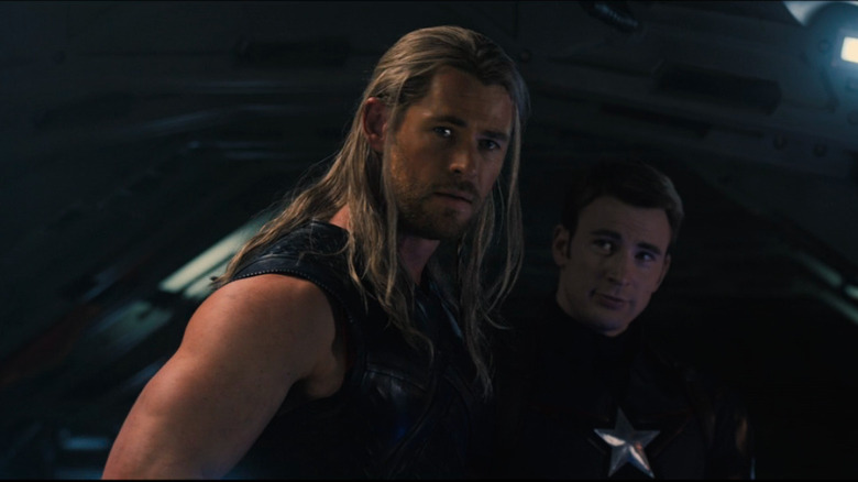 Thor looking over shoulder Captain America smiling