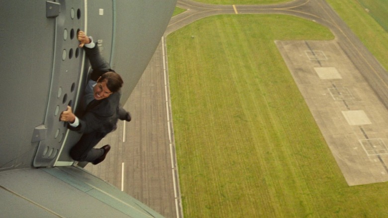 Ethan Hunt hangs on to a plane taking off