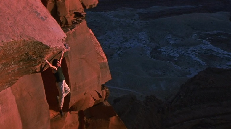 Ethan Hunt hangs onto a cliff