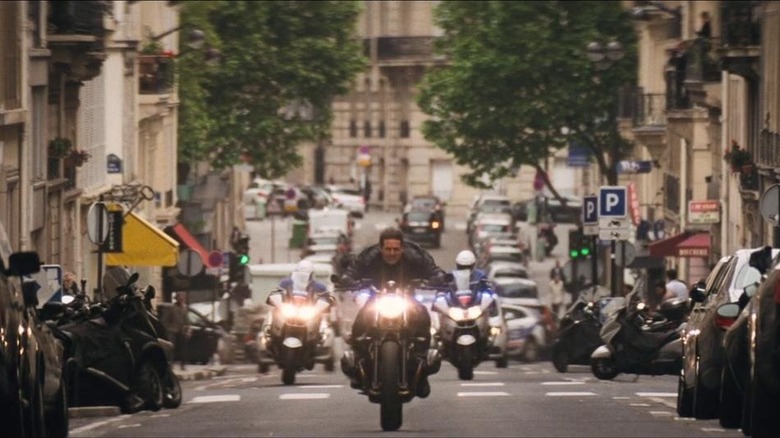 Ethan Hunt rides a bike pursued by police