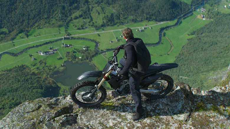 Ethan Hunt looks down a cliff from his motorcycle