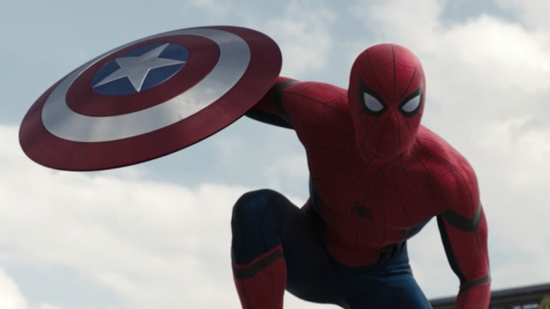 Spider-Man holding Captain American's shield