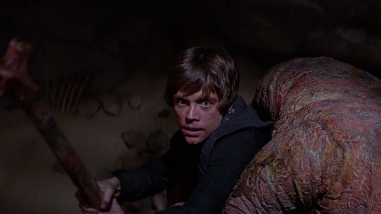 Luke fighting the rancor with a bone