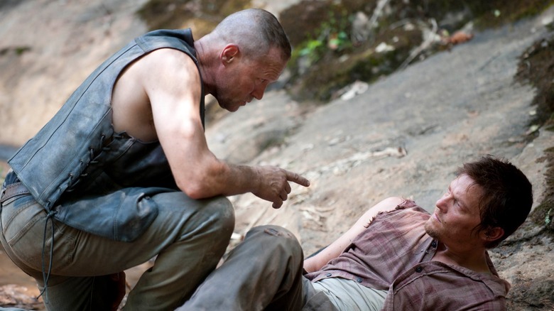 Merl pointing at Daryl on the ground The Walking Dead