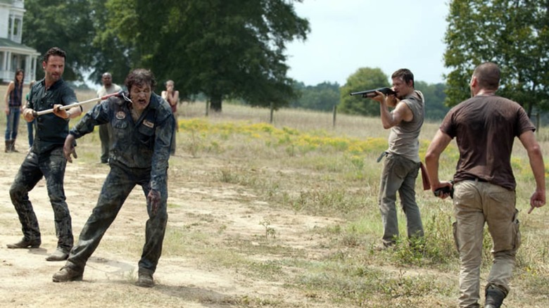 Rick, Daryl, and Shane wrangling walker The Walking Dead