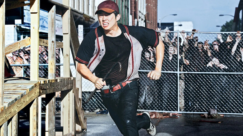 Glenn running from fenced in walkers The Walking Dead