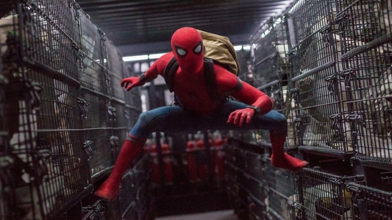 Spider-Man balances between cages