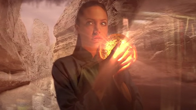 Lara Croft holding glowing globe