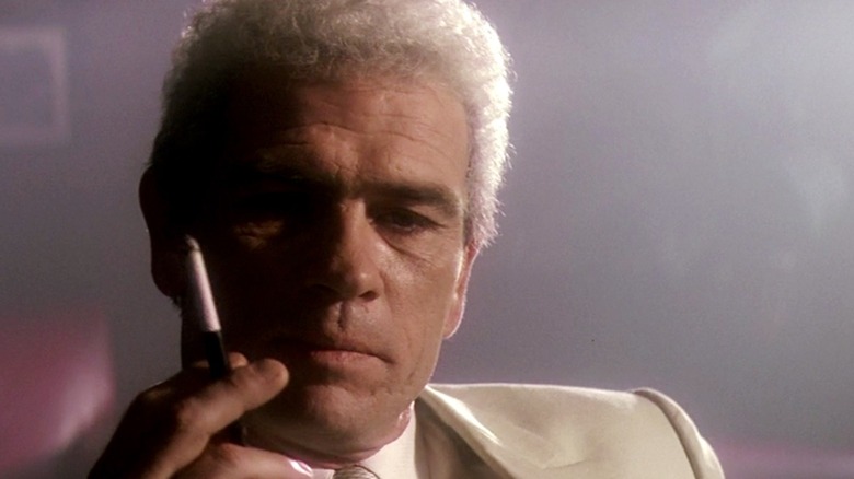 Claw Shaw holds a cigarette in "JFK" (1991)