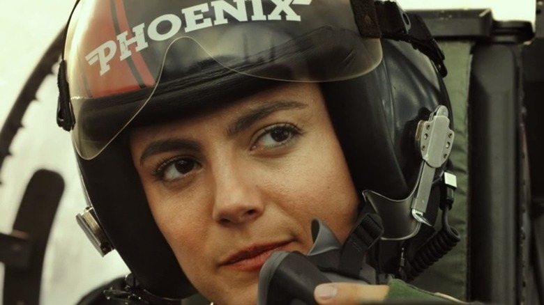 Phoenix sits helmeted in a fighter cockpit