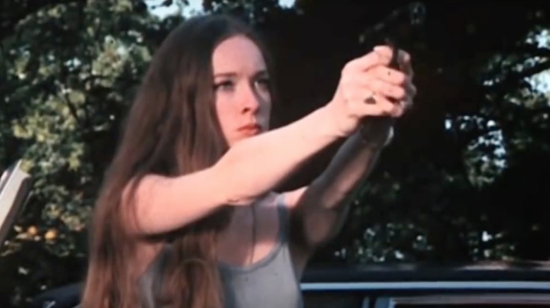 Woman aiming gun