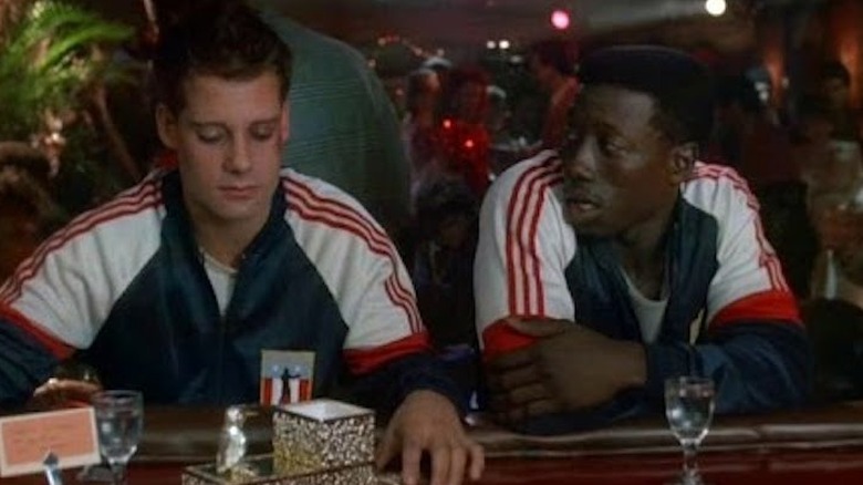 Wesley Snipes talks to his friend at a bar