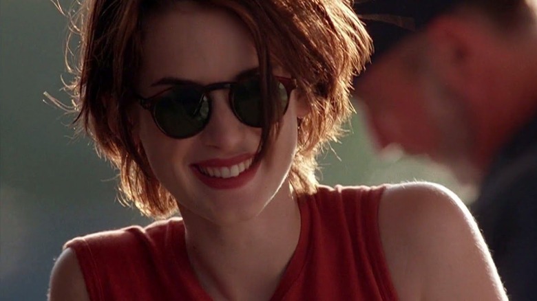 Winona Ryder smiles in sunglasses