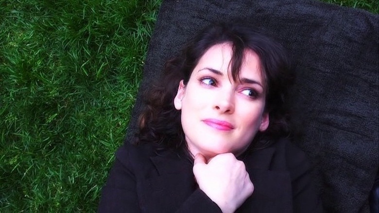 Winona Ryder lays in the grass