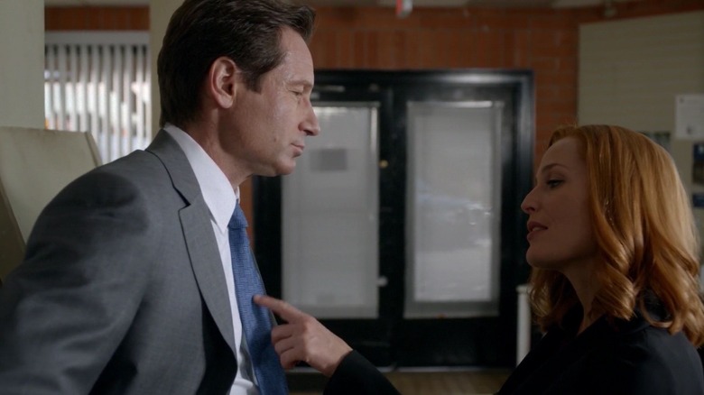 Scully touching Mulder's tie