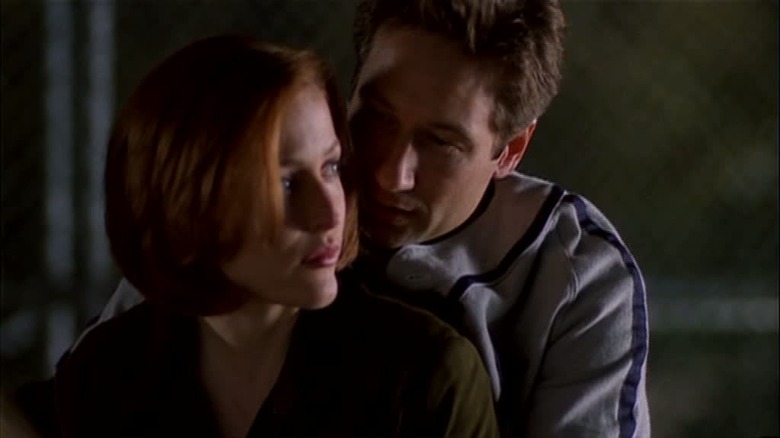 Mulder teaching Scully how to swing a baseball bat