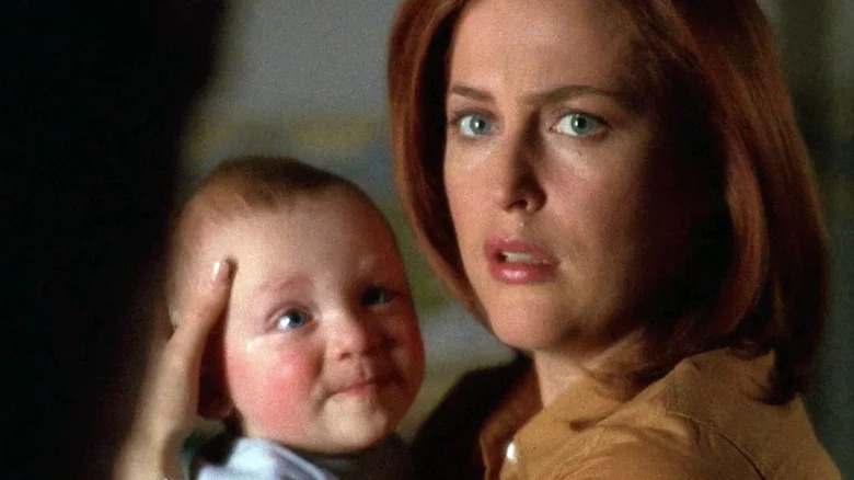 Scully holding baby