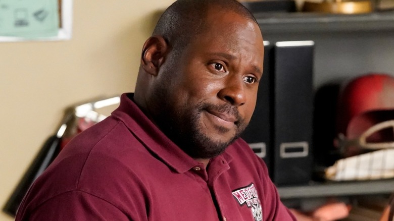 Coach Wayne Wilkins sits at his desk