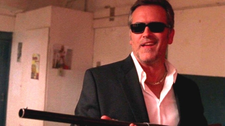 Sam Axe grinning with a gun