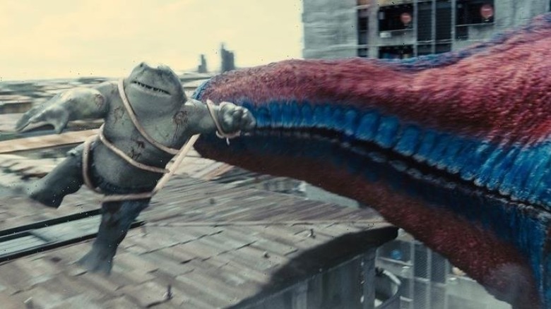 Starro's arm grabs King Shark