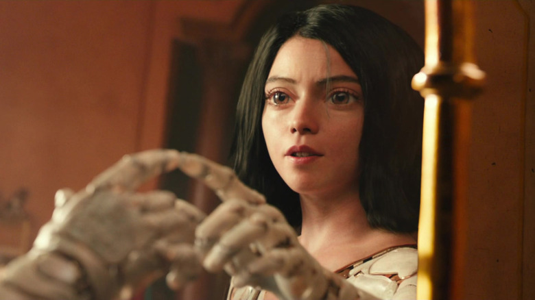 Alita touching mirror