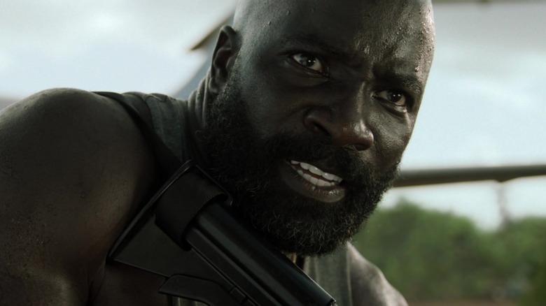 Mike Colter holds assault rifle