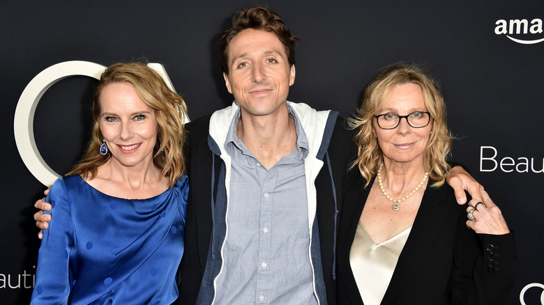 Amy, Nic and Vicki smile at camera on red carpet 